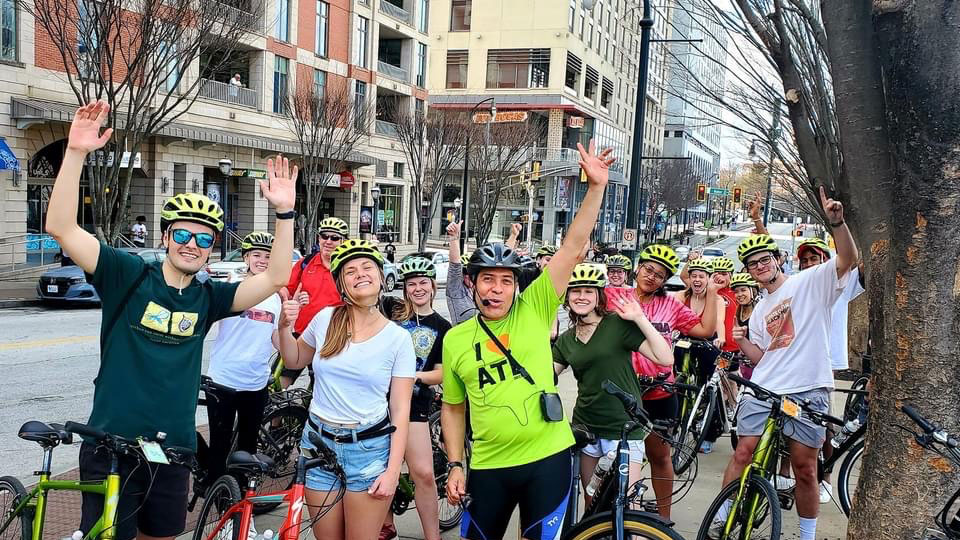 Photo of Jairo Garcia and students bike riding in the city 